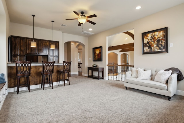 living room with visible vents, arched walkways, baseboards, light colored carpet, and recessed lighting