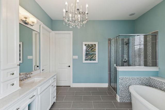 bathroom featuring a stall shower, vanity, baseboards, and a bathing tub