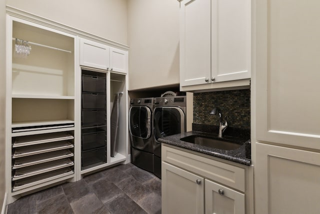 laundry area featuring cabinet space, washing machine and dryer, and a sink