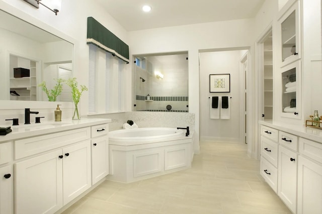 1909 Paxton Pass, Mckinney, TX 75071 - full bathroom featuring walk in shower, a garden tub, vanity, tile patterned flooring, and a walk in closet