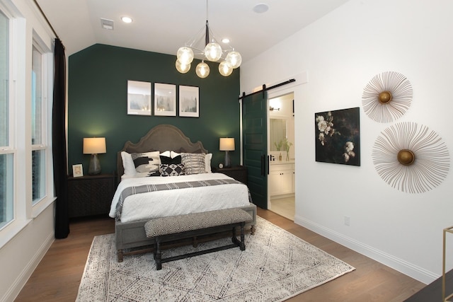1909 Paxton Pass, Mckinney, TX 75071 - bedroom with a barn door, wood finished floors, baseboards, a chandelier, and vaulted ceiling