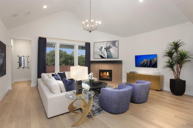 1909 Paxton Pass, Mckinney, TX 75071 - living area featuring a lit fireplace, wood finished floors, baseboards, recessed lighting, and a chandelier