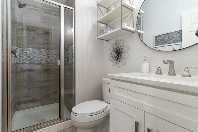 full bath with toilet, a stall shower, and vanity