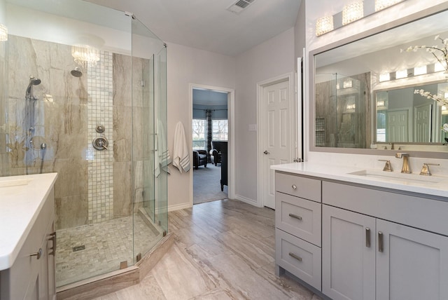 full bath with a stall shower, baseboards, visible vents, connected bathroom, and vanity