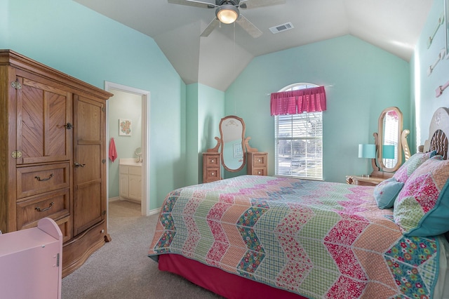 bedroom featuring lofted ceiling, visible vents, light carpet, ceiling fan, and ensuite bath