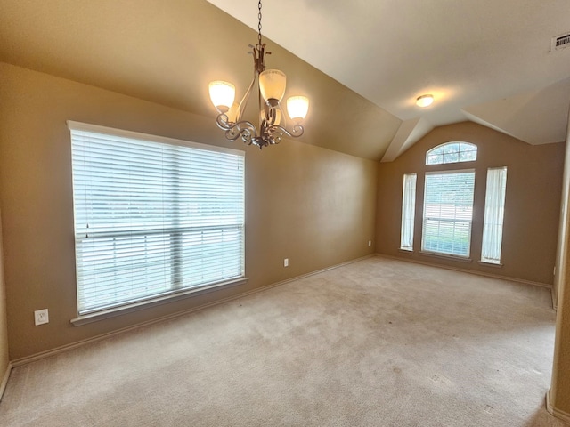 spare room featuring light carpet, visible vents, a chandelier, and vaulted ceiling