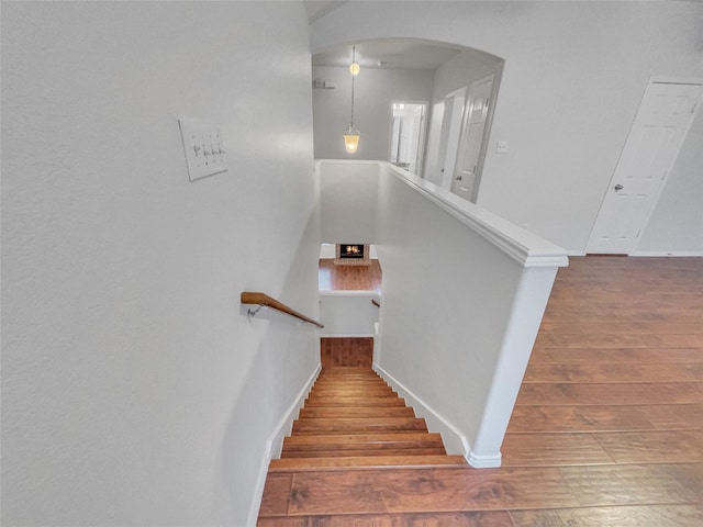 1825 Heron Dr, Aubrey, TX 76227 - staircase with arched walkways, wood finished floors, and baseboards