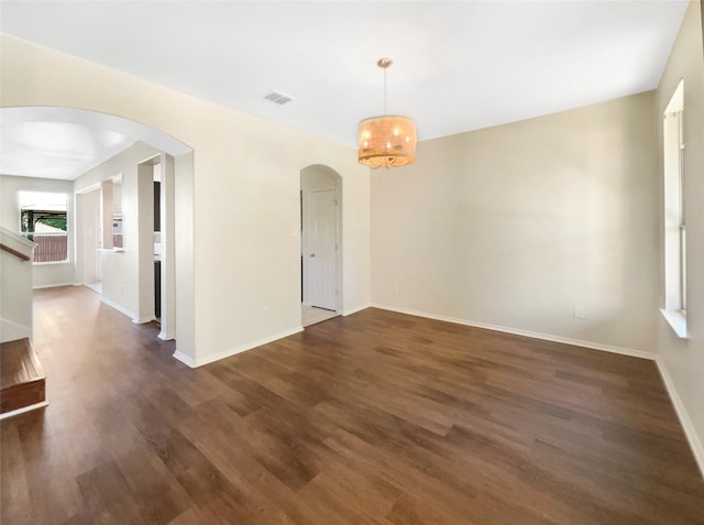 1825 Heron Dr, Aubrey, TX 76227 - spare room featuring arched walkways, wood finished floors, a chandelier, and baseboards