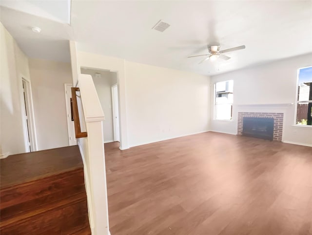 1825 Heron Dr, Aubrey, TX 76227 - unfurnished living room featuring ceiling fan, wood finished floors, a fireplace, and baseboards