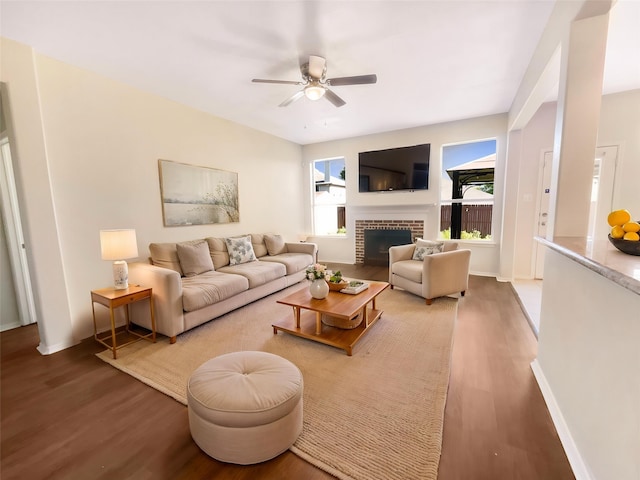 1825 Heron Dr, Aubrey, TX 76227 - living room with wood finished floors, a ceiling fan, a fireplace, and baseboards