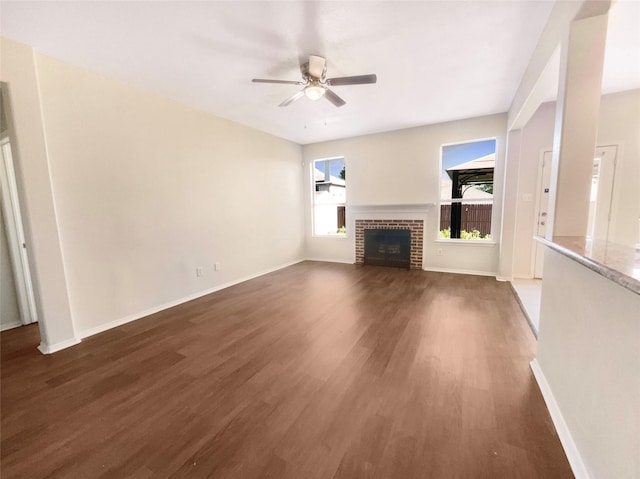 1825 Heron Dr, Aubrey, TX 76227 - unfurnished living room with wood finished floors, ceiling fan, baseboards, and a fireplace