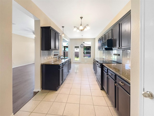 1825 Heron Dr, Aubrey, TX 76227 - kitchen featuring black electric range, a sink, decorative backsplash, and dark stone counters