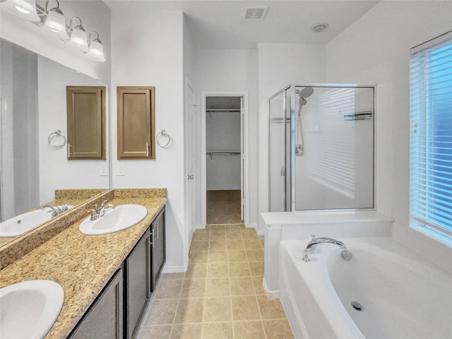 1825 Heron Dr, Aubrey, TX 76227 - bathroom featuring a shower stall, double vanity, a garden tub, a spacious closet, and tile patterned flooring