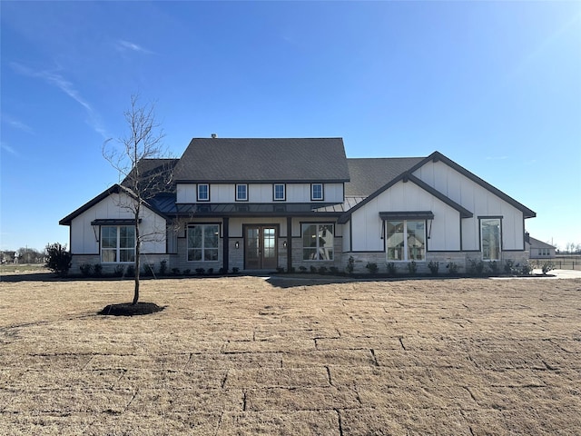 modern farmhouse style home featuring board and batten siding, a standing seam roof, metal roof, and a front lawn