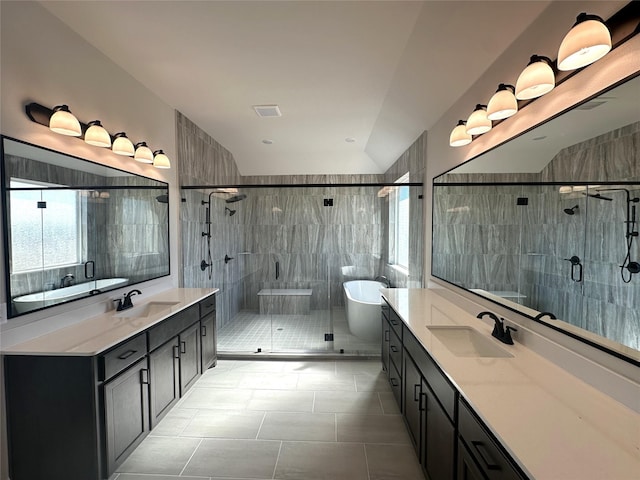 full bathroom featuring two vanities, visible vents, a sink, and a freestanding bath