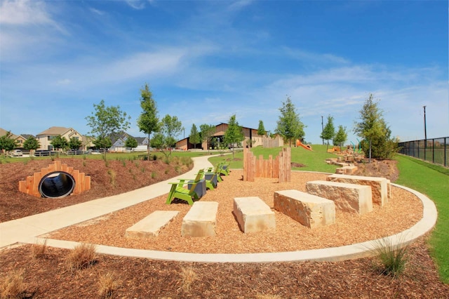 view of home's community featuring fence and a residential view