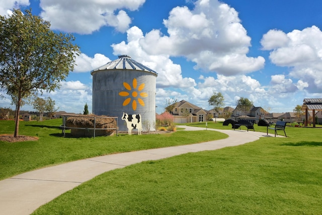 view of property's community with a residential view and a lawn