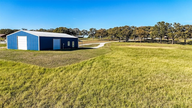 view of yard featuring a garage and an outbuilding