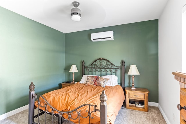 carpeted bedroom featuring an AC wall unit, a ceiling fan, and baseboards