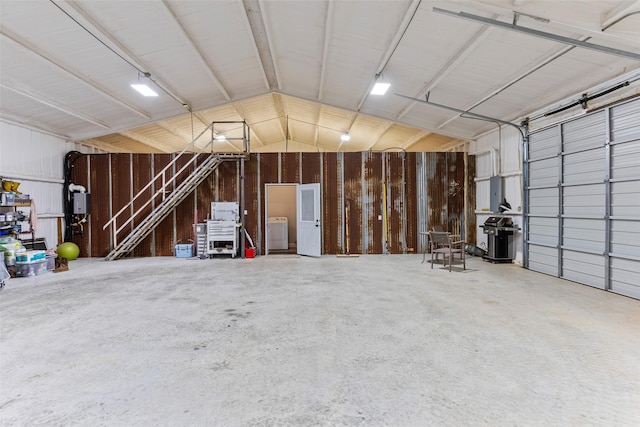 garage featuring washer / clothes dryer and metal wall