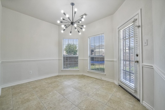 empty room with a chandelier, light tile patterned floors, visible vents, and baseboards