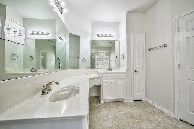 bathroom with baseboards, a closet, and vanity