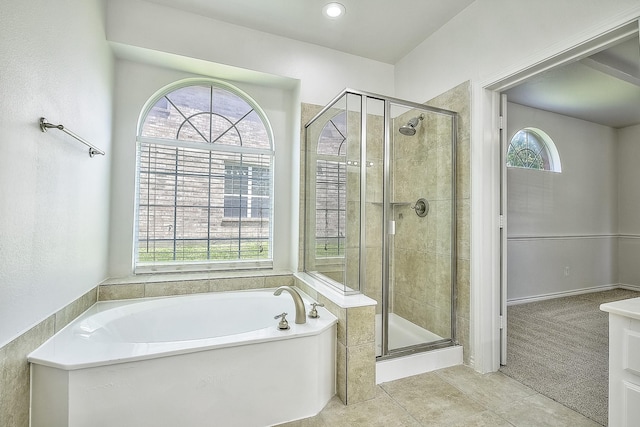 bathroom with a bath, a stall shower, a wealth of natural light, and tile patterned floors