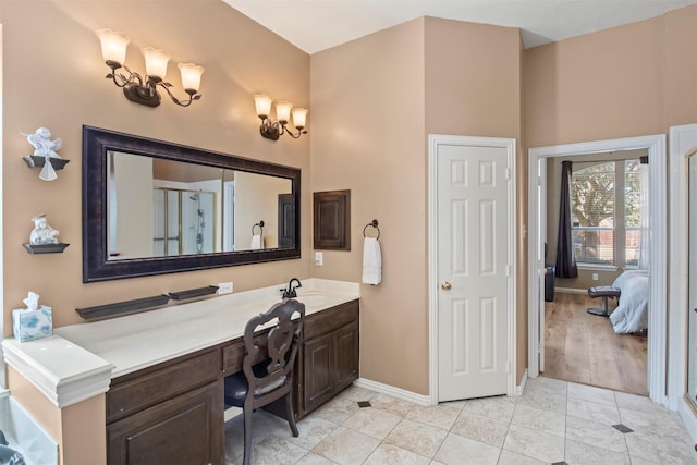 full bathroom with tile patterned flooring, baseboards, vanity, and a shower stall