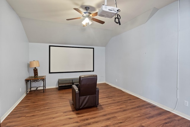 home theater with a ceiling fan, lofted ceiling, baseboards, and wood finished floors