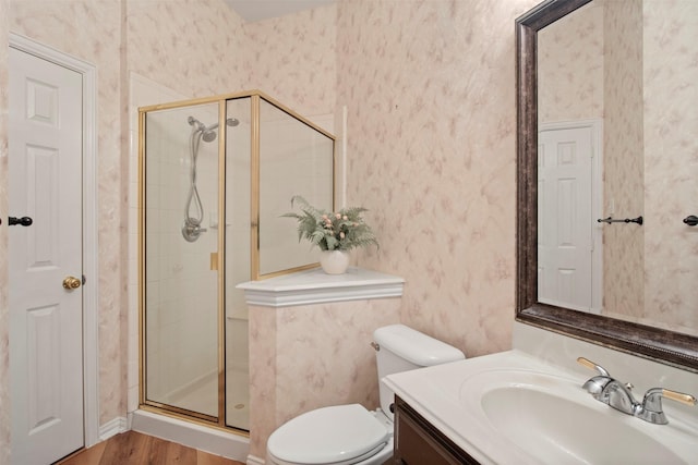 full bathroom featuring a shower stall, toilet, and wallpapered walls