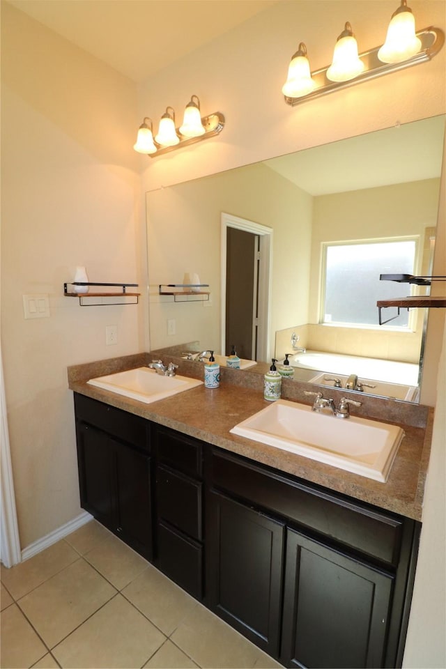 bathroom with double vanity, a tub to relax in, a sink, and tile patterned floors