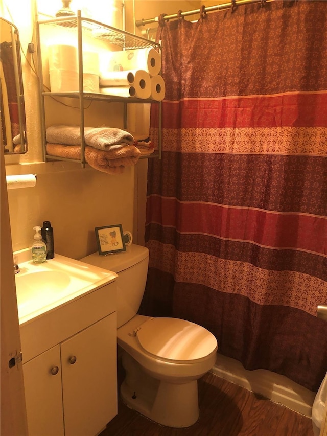 bathroom with toilet, curtained shower, and vanity