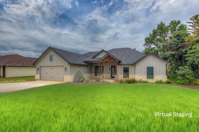 modern farmhouse style home featuring roof with shingles, concrete driveway, an attached garage, stone siding, and a front lawn