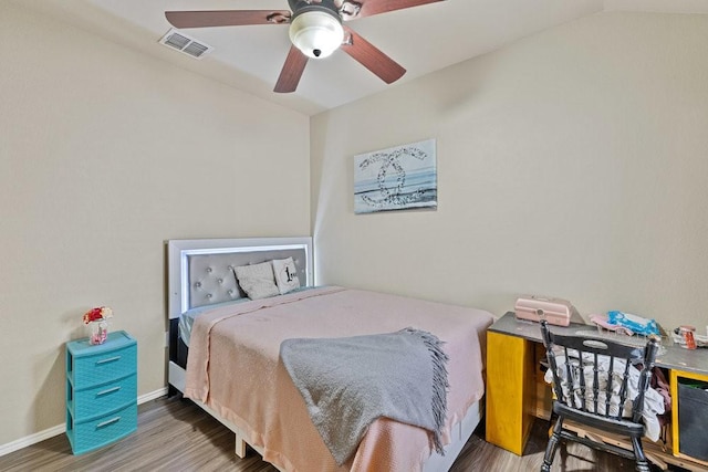 bedroom with visible vents, ceiling fan, baseboards, and wood finished floors