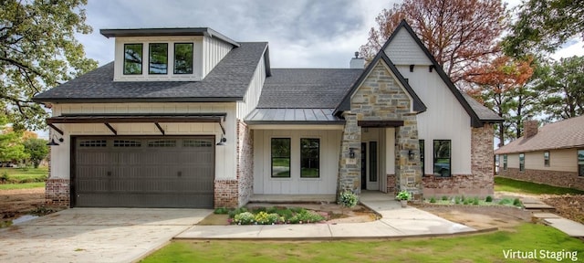 view of front facade featuring brick siding, roof with shingles, concrete driveway, a standing seam roof, and metal roof