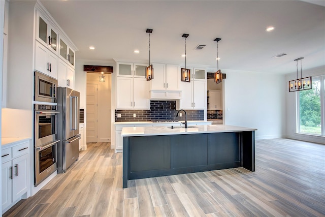 kitchen featuring light countertops, glass insert cabinets, and white cabinets