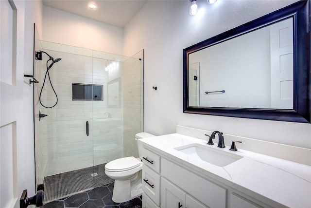 full bathroom featuring a stall shower, vanity, toilet, and tile patterned floors