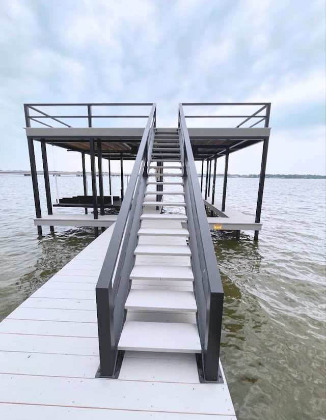 dock area with a water view and boat lift