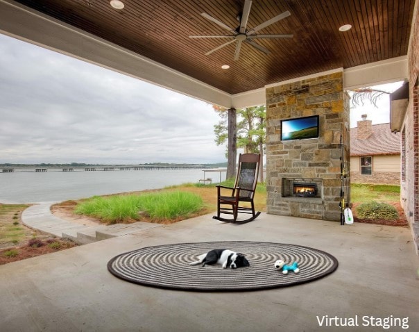 view of patio / terrace with an outdoor stone fireplace and a ceiling fan