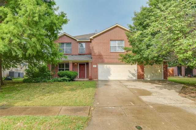 traditional-style house with a garage, driveway, brick siding, and a front lawn