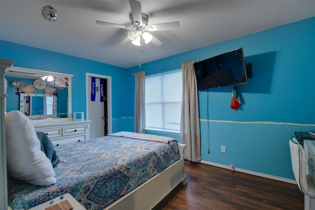 bedroom featuring ceiling fan, dark wood-type flooring, and baseboards