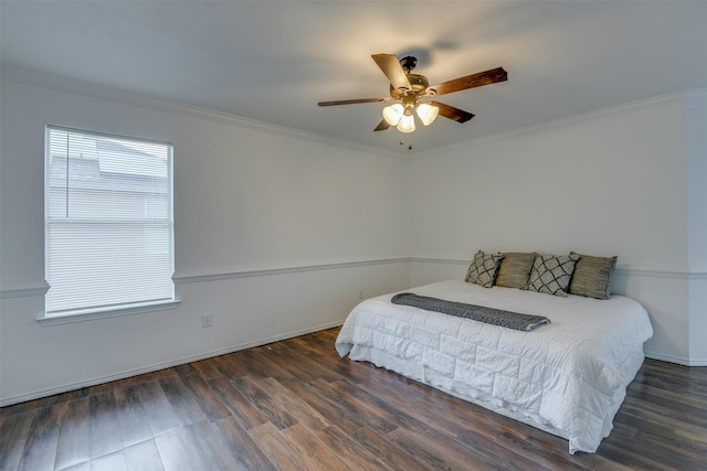 bedroom with baseboards, a ceiling fan, dark wood-type flooring, and crown molding