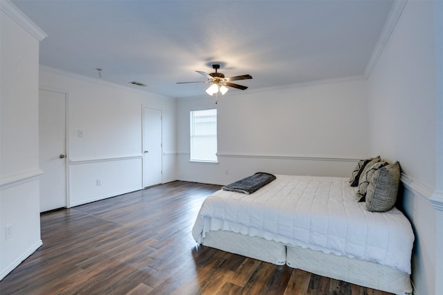 bedroom with ornamental molding, dark wood finished floors, and visible vents