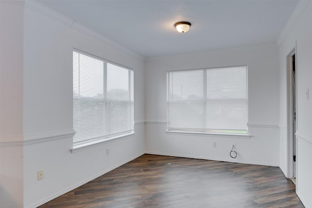 unfurnished room featuring ornamental molding, dark wood-style flooring, and baseboards