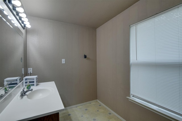 bathroom featuring vanity, baseboards, and tile patterned floors