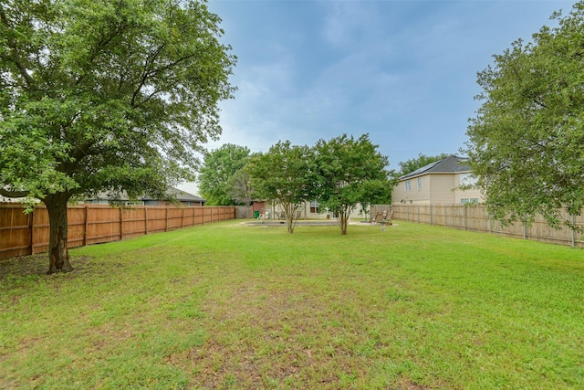 view of yard with a fenced backyard