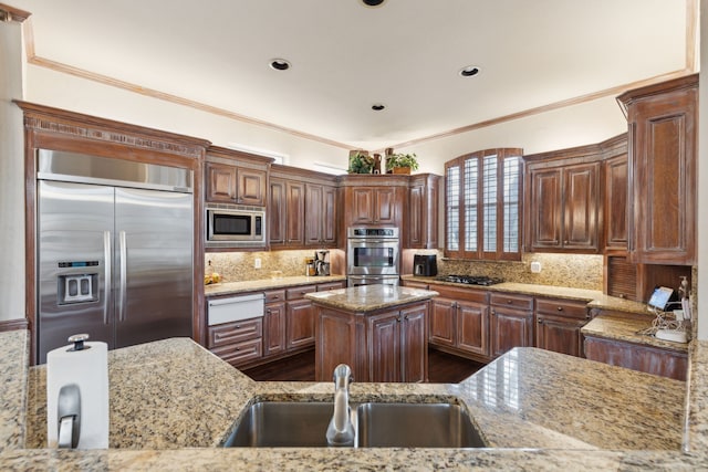 kitchen featuring built in appliances, light stone counters, a sink, a center island, and a warming drawer