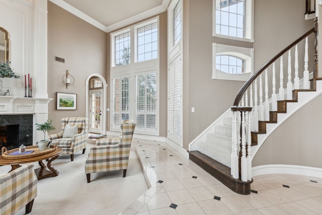 interior space featuring visible vents, ornamental molding, light tile patterned flooring, and a high end fireplace