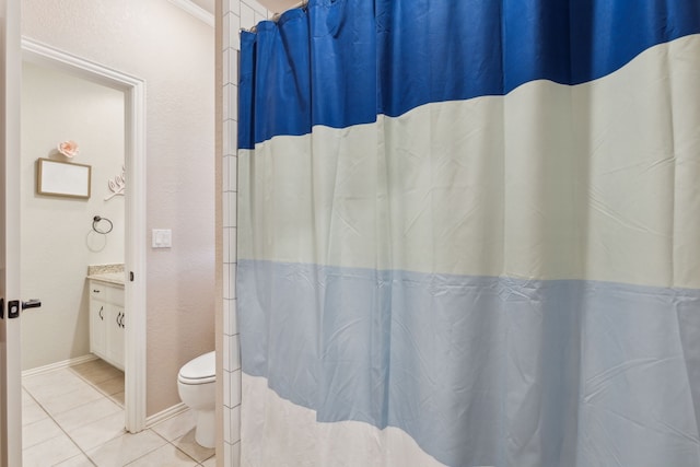 bathroom featuring toilet, vanity, and tile patterned floors