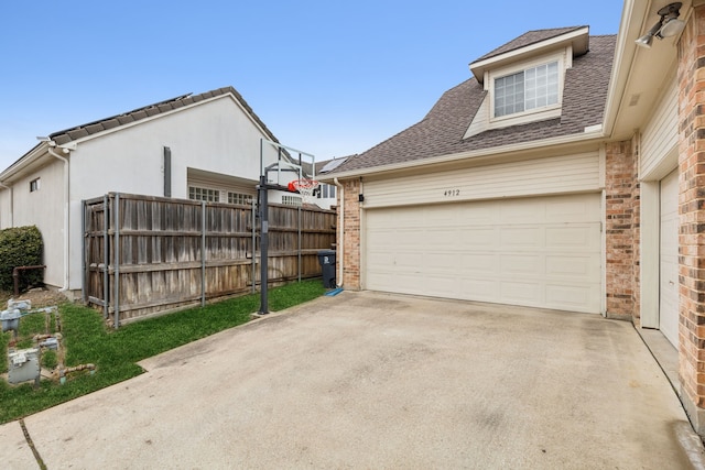 exterior space with driveway and fence